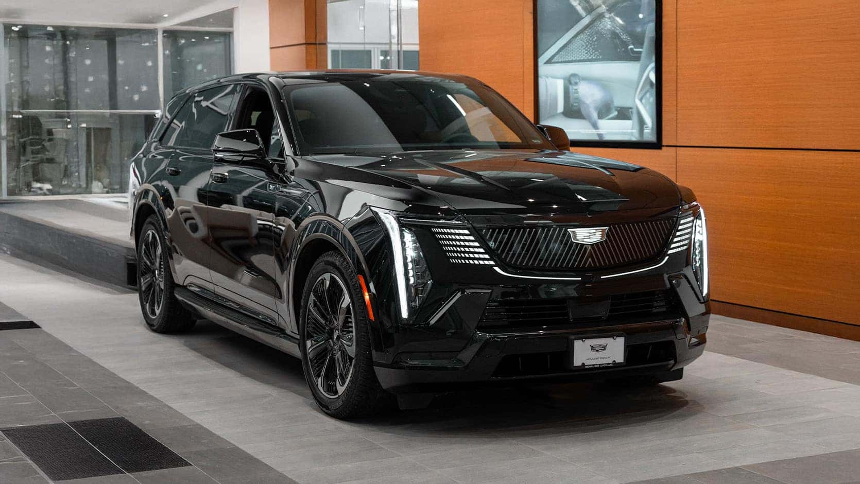 Luxurious black SUV with modern LED headlights in a sleek showroom.
