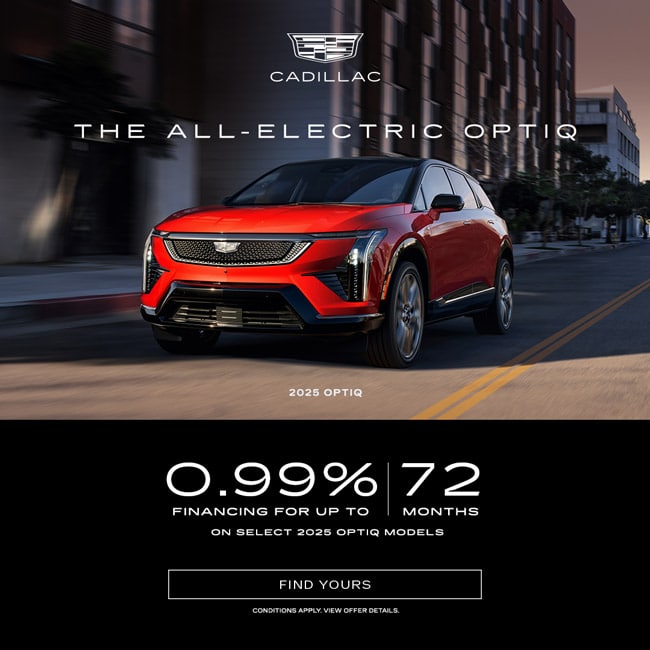 Red Cadillac Optiq driving in urban setting, promoting 0.99% financing for 72 months on 2025 models.